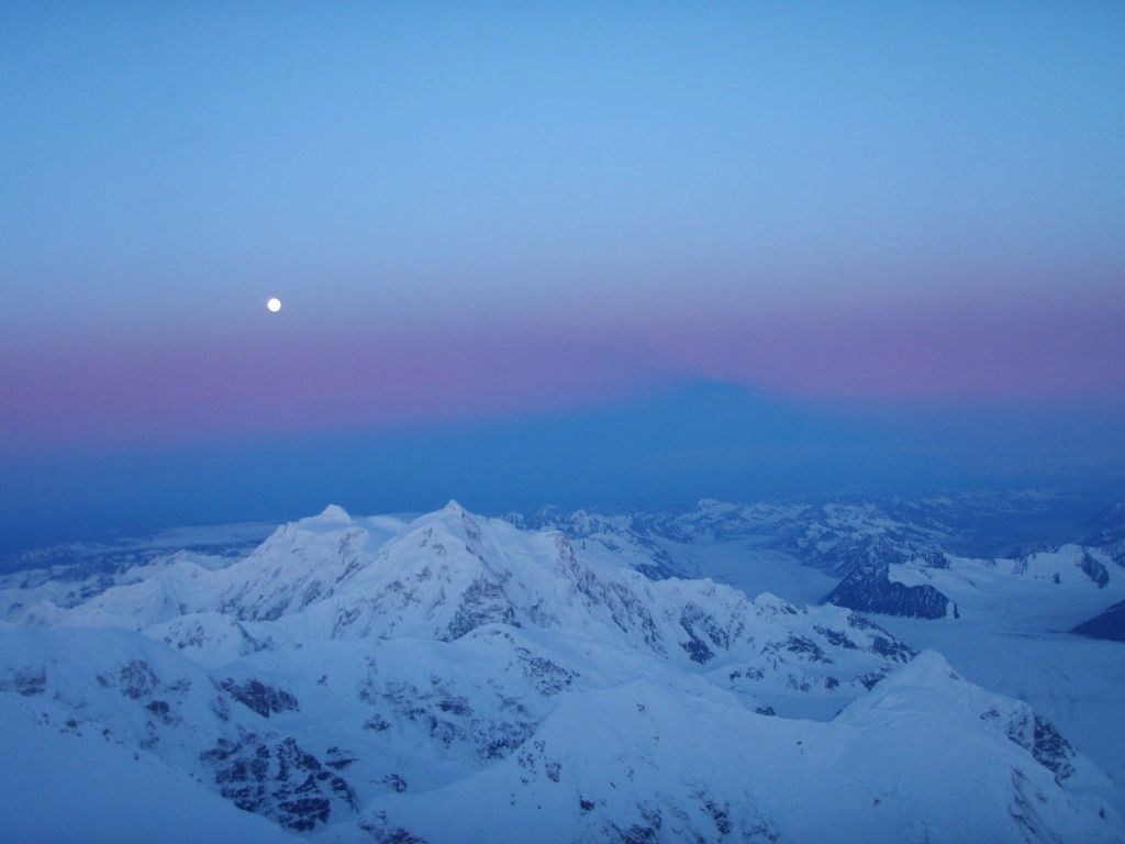 Moon above snowy mountains